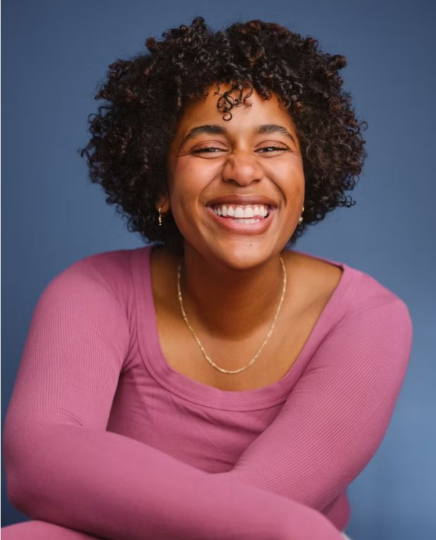 Smiling woman in pink sweater